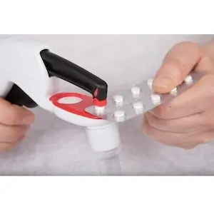 Pivotell Pill Popper Tool in use popping pills from blister pack